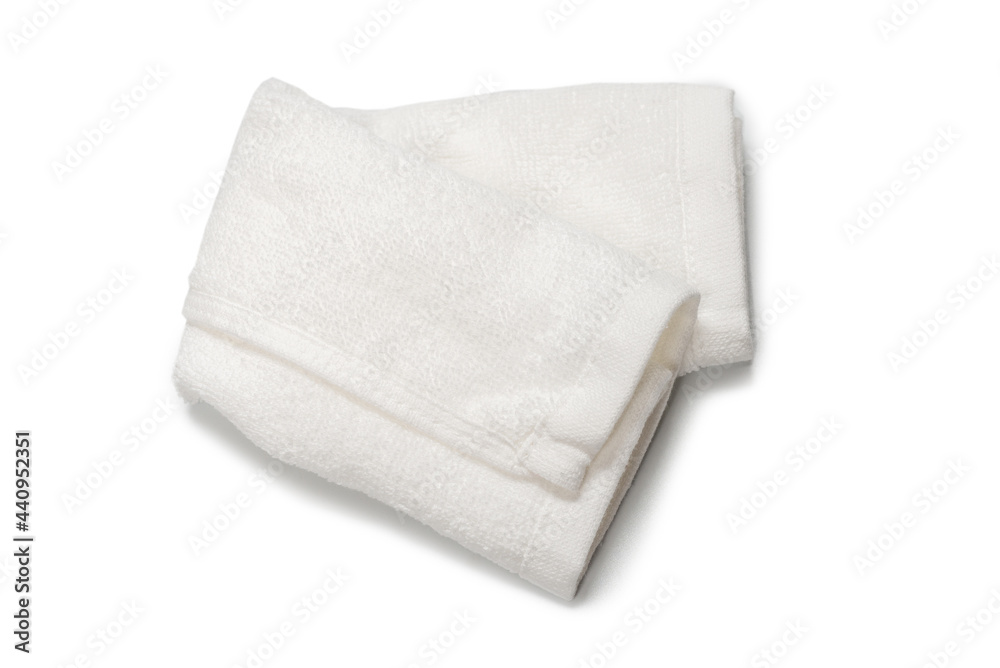 White fluffy cotton towel isolated on a white background. White fluffy cotton towel isolated on a white background.