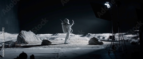 WIDE Male actor in astronaut suit making selfie on a Moon Lunar movie shooting set. Shot with 2x anamorphic lens photo