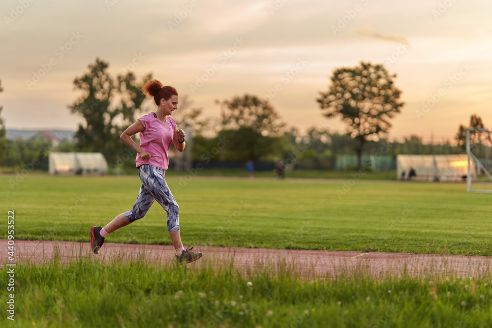 Woman running on track Woman running on track
