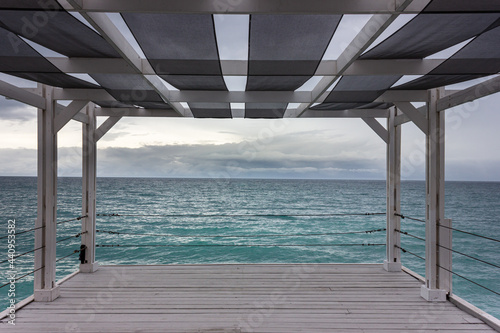 Access to the sea  the horizon in infinity  the embankment under the roof  under the canopy