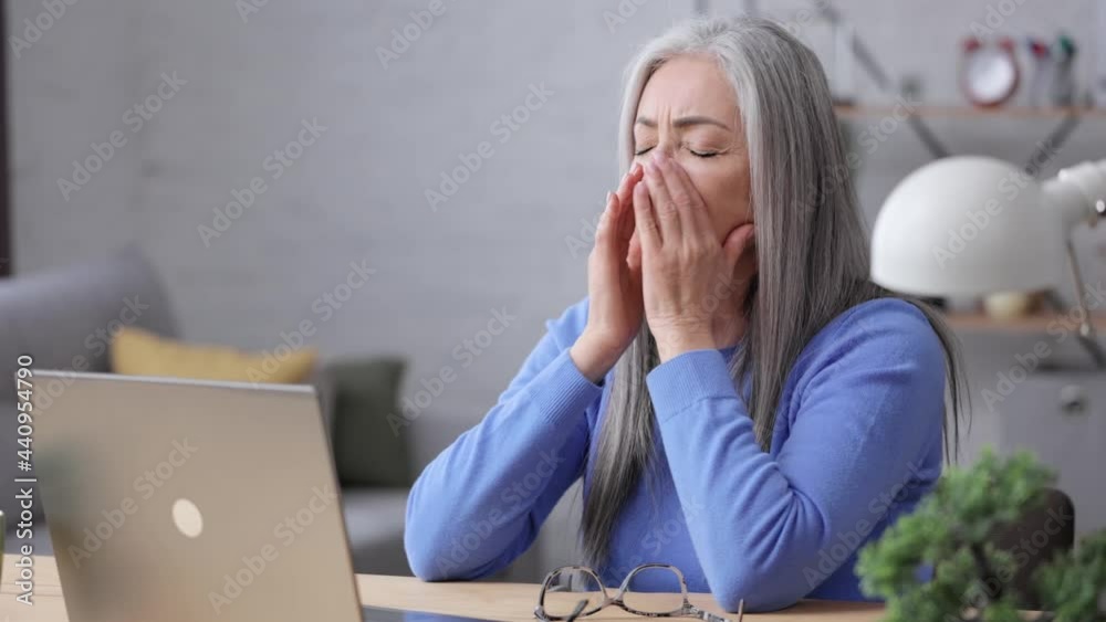 Depressed mature woman overworked on laptop computer. Tired worker recieved bad online news about dismissal from work. Financial crisis, burnout syndrome, overworking, depression, apathy. Depressed mature woman overworked on laptop computer. Tired worker recieved bad online news about dismissal from work. Financial crisis, burnout syndrome, overworking, depression, apathy.