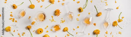Trendy Orange or Amber wine and yellow flowers, wide composition