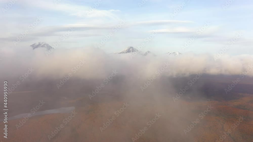 custom made wallpaper toronto digital4k drone footage. Aerial view of camera going above autumn forest with low clouds. Foggy day at Kamchatka peninsula. Volcanoes on the background. Tourism
