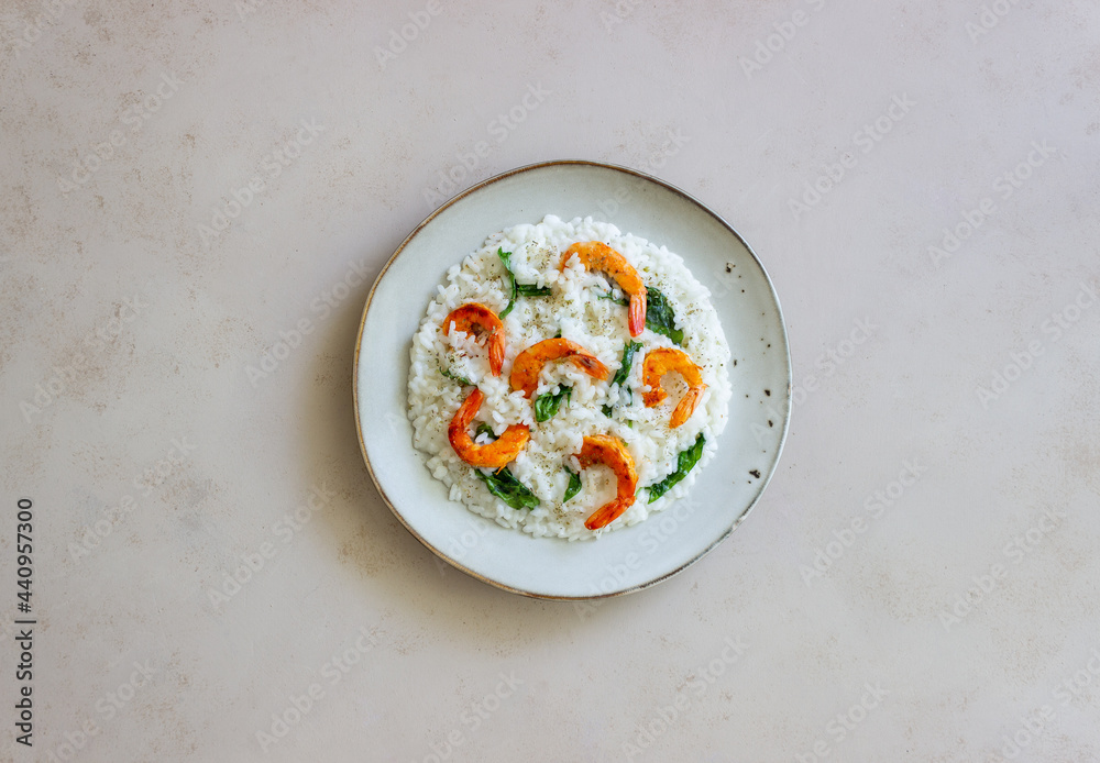 Risotto with shrimps and spinach. Healthy food. Vegetarian food. Risotto with shrimps and spinach. Healthy food. Vegetarian food.