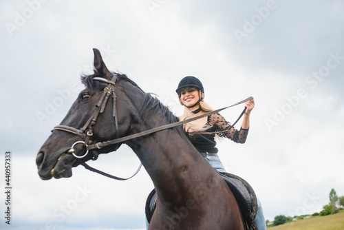 Beautiful girl riding a horse in countryside.