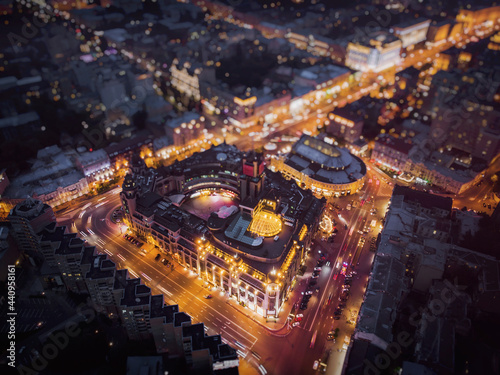 Night landscape of the city with a trapezoidal crossroads and a building in the center