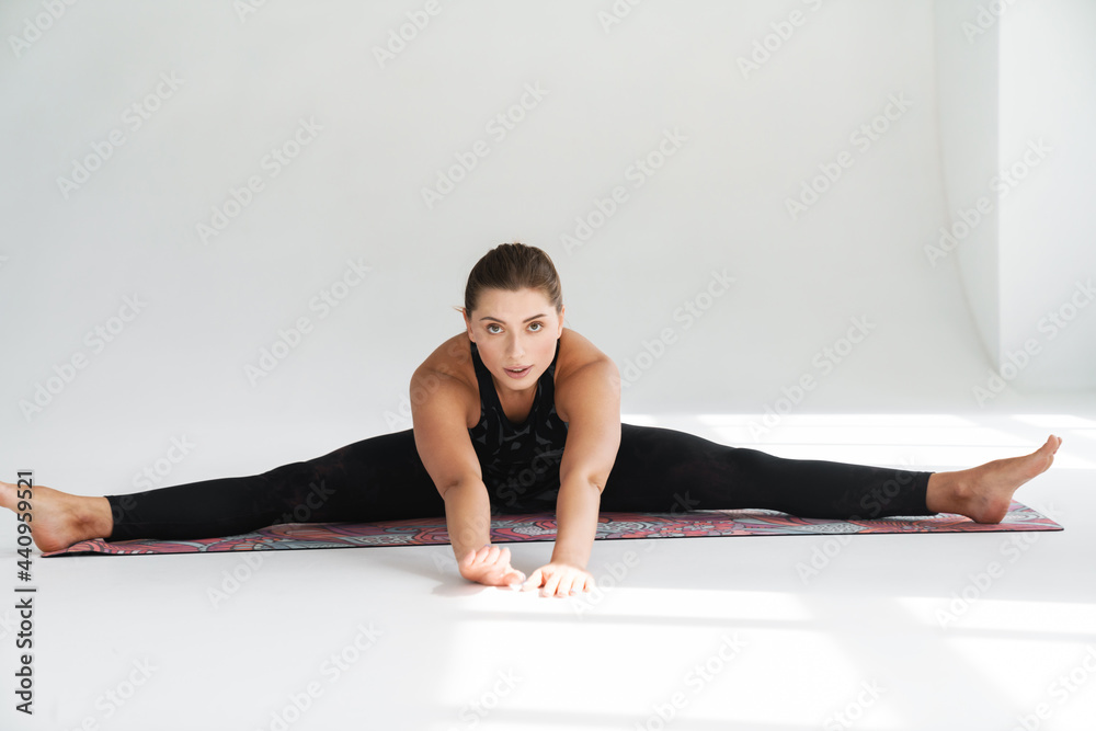 Flexible young white woman in sportswear exercising Flexible young white woman in sportswear exercising