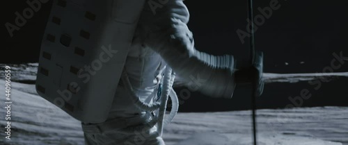 Portrait of Asian lunar astronaut placing a flag pole on the Moon surface. Easy to track and add your flag. Shot with 2x anamorphic lens