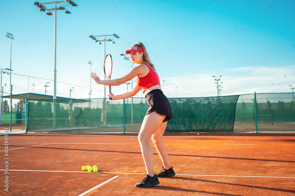 young woman plays tennis on the court. Serves the ball, sports team game. Active lifestyle, outdoor recreation, body fitness. nice weight loss. The girl smiles, happy. Portrait of an athlete