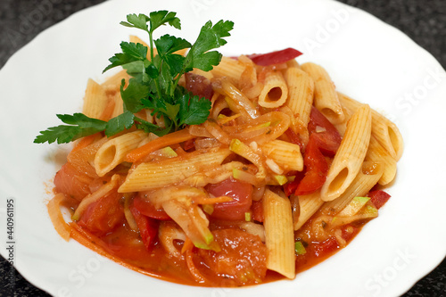 Penne pasta cooked with stewed vegetables and herbs