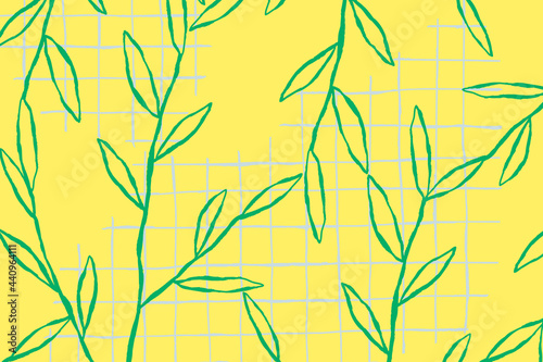 Fototapeta Naklejka Na Ścianę i Meble -  Green leaf pattern on yellow grid background
