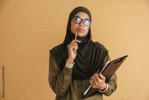 Black muslim woman in hijab posing with clipboard