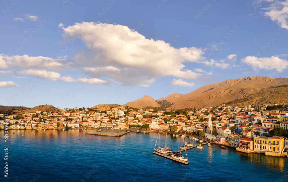 Aerial view of the port of the Greek island of Chalki with the typical colored houses in the Dodecanese archipelago