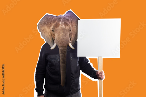 Man with elephant face holds a banner. Concept - protest action on theme of nature. Protest of green activists. Protector of nature with blank banner. Elephant as metaphor for protector of nature. photo