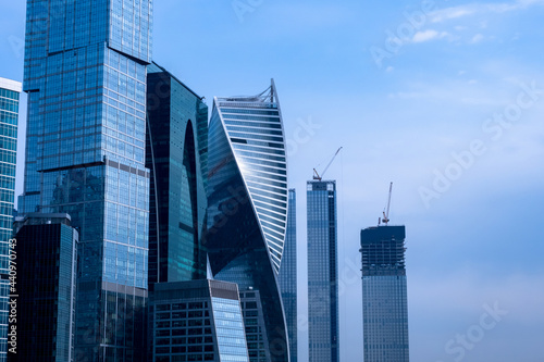 Modern business center city. Glass skyscrapers on blue sky background. Contemporary downtown architecture. Unfinished skyscrapers near downtown. Moscow architecture. Modern architecture in Russia.