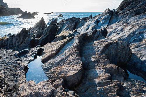 Beautiful rocky bay Ilfracombe beach, Exmoor, North Devon, surrounded by the cliffs, view of the sea and stones, selective focus photo