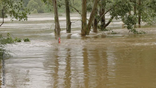 zoom in on a partially submerged road sign during the nepean river flood in nsw, australia