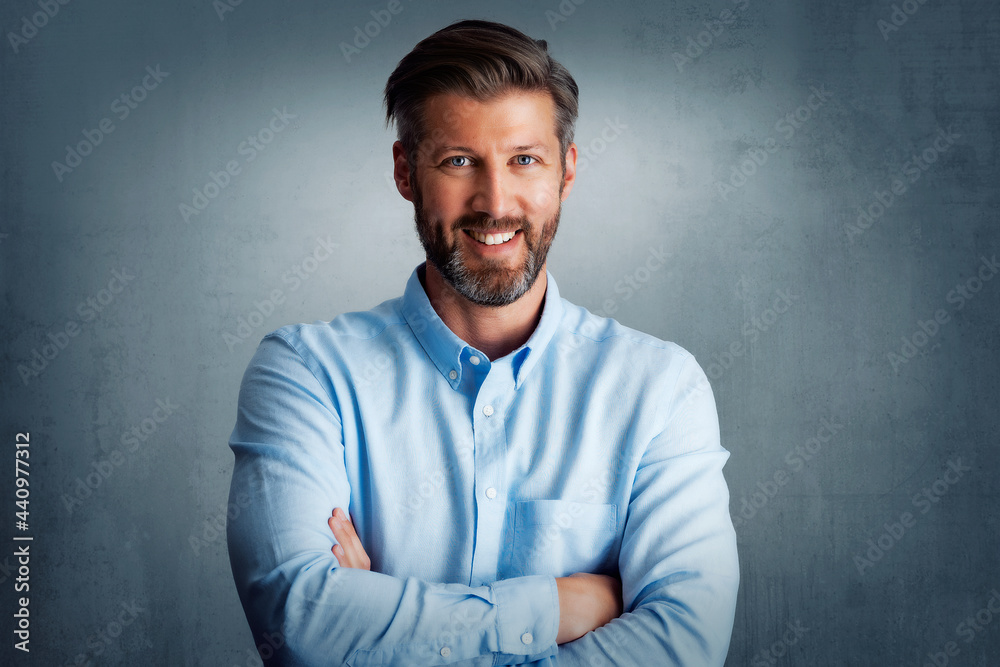 Confident and happy man standing at isolated background