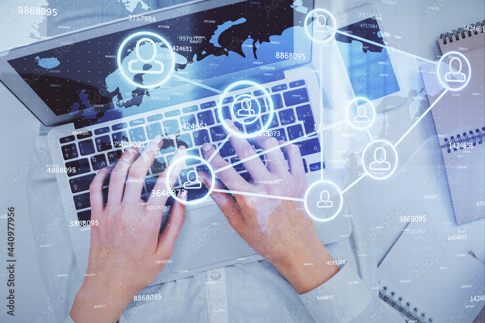 Double exposure of woman hands working on computer and social network theme hologram drawing. Top View. People connection concept. Double exposure of woman hands working on computer and social network theme hologram drawing. Top View. People connection concept.