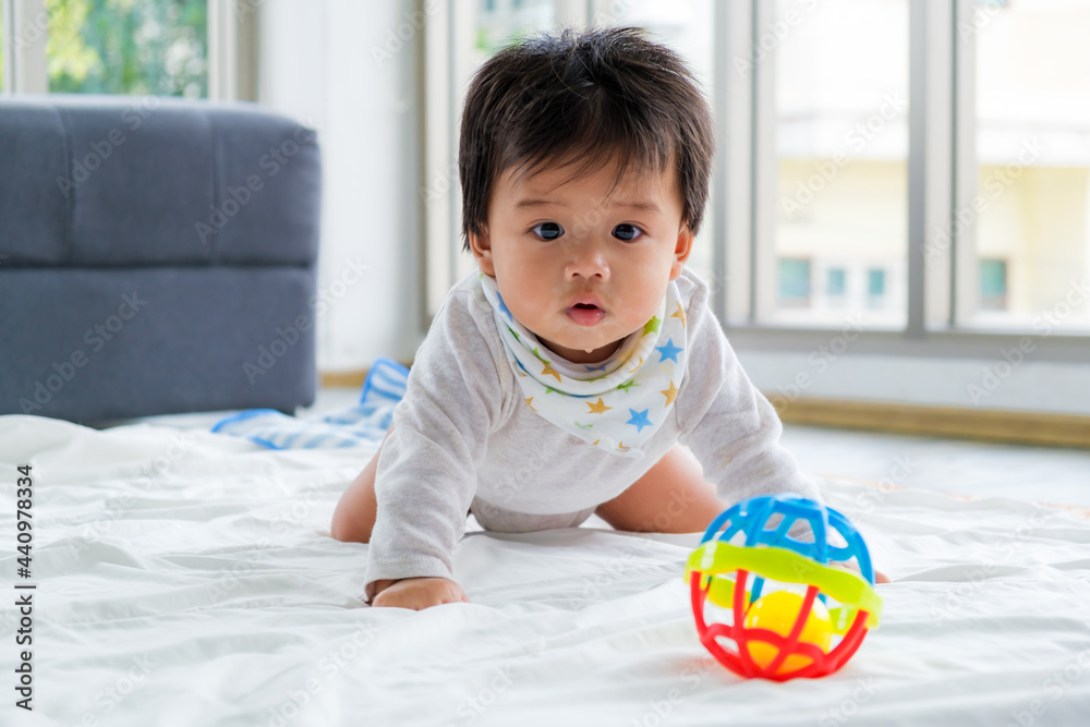 The little boy was lying on the floor. Still unable to walk. Crawling only. Baby healthcare and family concept. The little boy was lying on the floor. Still unable to walk. Crawling only. Baby healthcare and family concept.