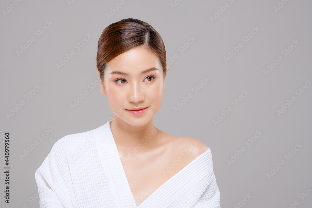 Beauty asian face young beautiful woman skin natural make up. close up fpretty portrait spa and salon in bathing suit. beautiful skin care cosmetic concept.Gray background. Smile happy mood. Beauty asian face young beautiful woman skin natural make up. close up fpretty portrait spa and salon in bathing suit. beautiful skin care cosmetic concept.Gray background. Smile happy mood.