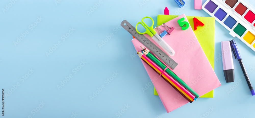 Fototapeta premium School supplies on a blackboard background ready for your design