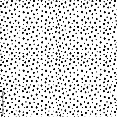 Vector seamless random small black polka dot pattern on white background. Irregular chaotic points. Simple modern decorative hand drawn print for design, textile, wrapping paper, scrapbooking.