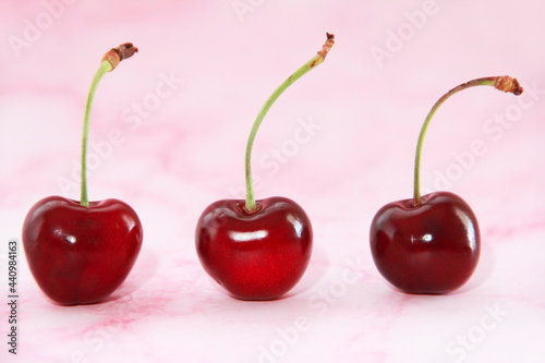 natural red cherry fruit with green peduncle