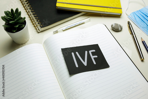 IVF (In Vitro Fertilization) written on open notebook photo