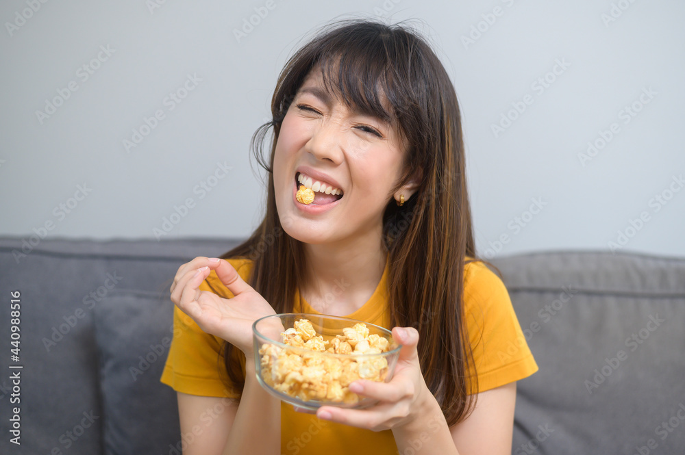 Young happy woman watching movie and relaxing at home Young happy woman watching movie and relaxing at home