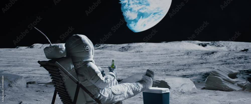 CRANE Back view of lunar astronaut having a beer while resting in a beach chair on Moon surface, enjoying view of Earth. Shot with 2x anamorphic lens