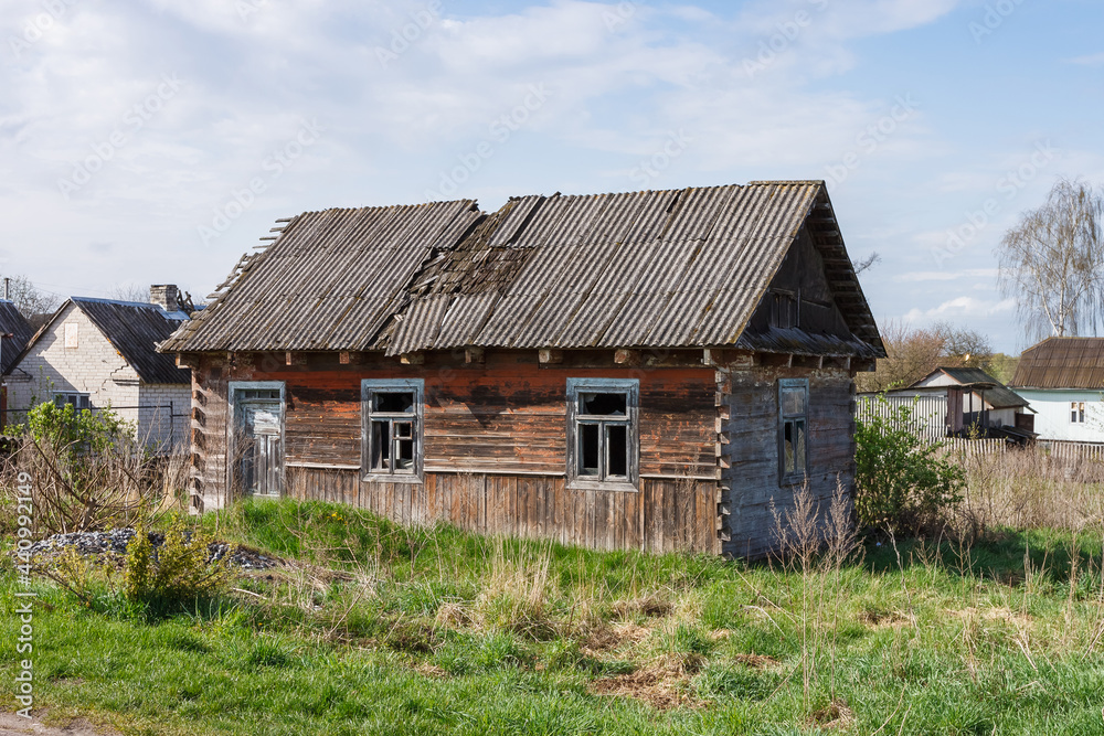 Abandoned old wooden house among the trees. Rural spring landscape. Abandoned old wooden house among the trees. Rural spring landscape.