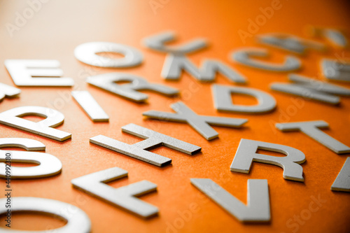 Canvas Print Mixed letters pile close up view. Orange background