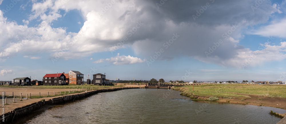 River Blyth at Walberswick, Suffolk with rain clouds and sun