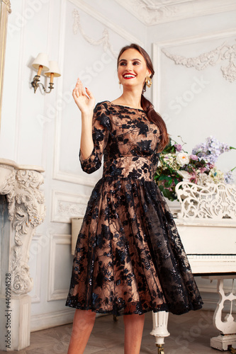 Tela young pretty lady in black lace fashion style dress posing in rich interior of r