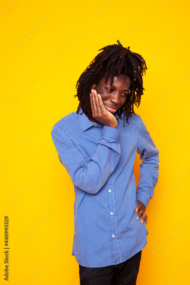 young handsome african american guy student posing cheerful and gesturing on yellow background, lifestyle people concept young handsome african american guy student posing cheerful and gesturing on yellow background, lifestyle people concept