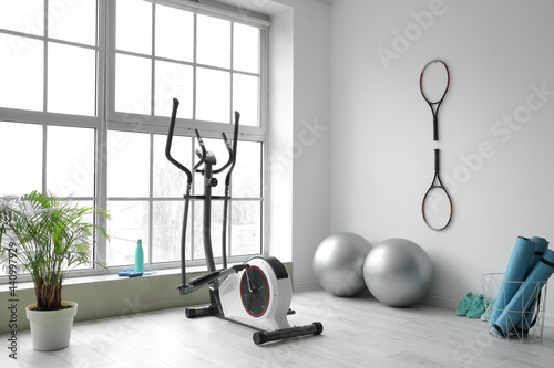 Different sports equipment and fitness balls in gym