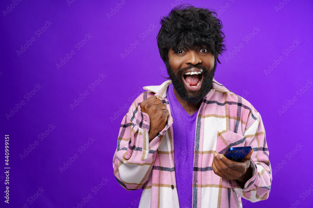 Portrait of excited successful young man with mobile phone Portrait of excited successful young man with mobile phone