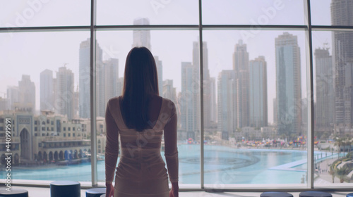 Businesswoman and large window in office building