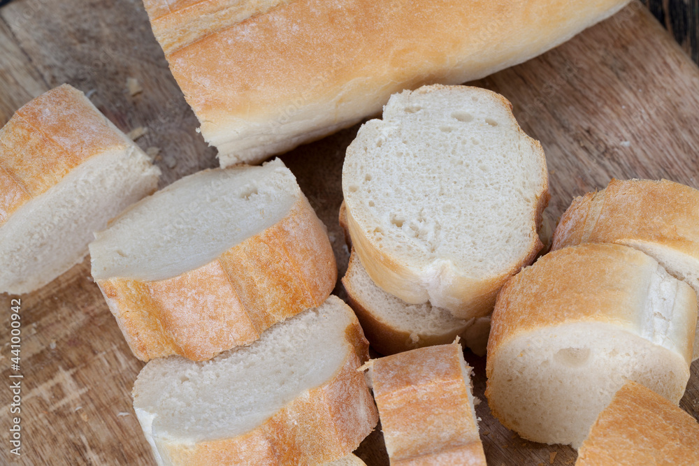 loaf of wheat baguette cut into slices loaf of wheat baguette cut into slices