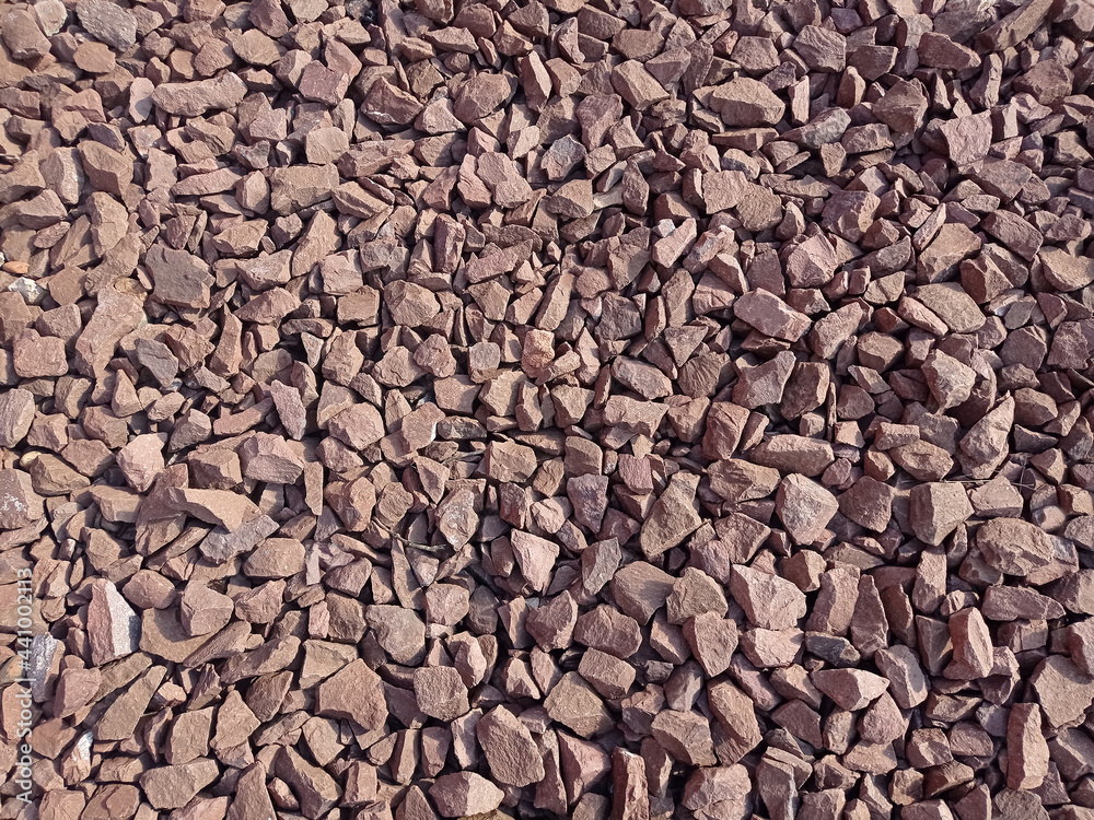 Texture crushed stone with a red hue in the side light Texture crushed stone with a red hue in the side light