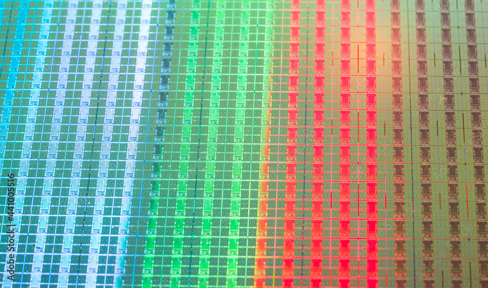 silicon wafer with microchips reflecting different colors. silicon wafer with microchips reflecting different colors.