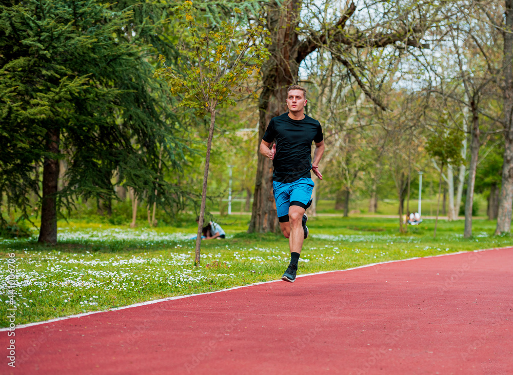 Young strong male fitness model during run outdoors in beautiful landscape Young strong male fitness model during run outdoors in beautiful landscape