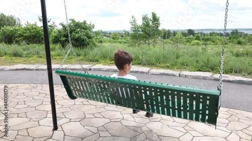 Boy swinging on a swing photo