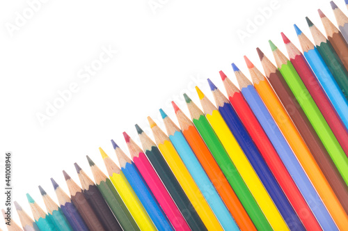 Many colorful pencils in a diagonal row isolated on white background