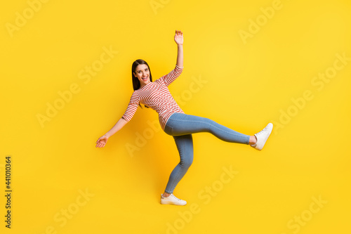 Full length body size view of attractive cheerful girl dancing fooling having fun isolated over bright yellow color background