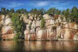 nordic rocky shore, trees on cliffs. Gulf of Finland, Vyborg bay, Monrepos park skyline.