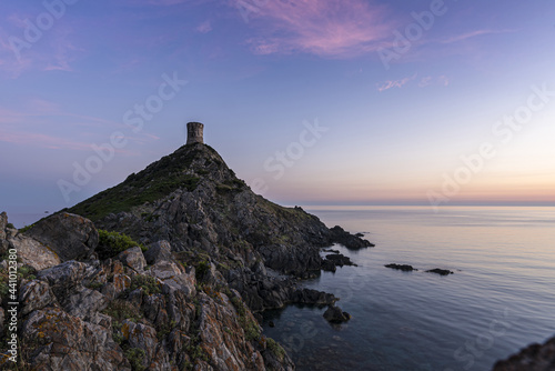 Corsican islands Sanguinaires under beautiful sunset light with a tower on the top of the rocky hill overlooking the Mediterranean sea. France 2021