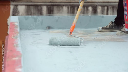 Hand painted gray flooring with paint rollers for waterproof, reinforcing net,Repairing waterproofing deck flooring.	