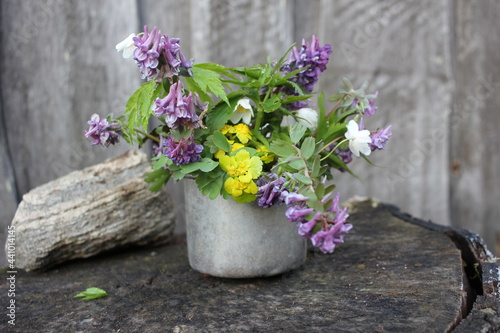 flowers in a pot on wooden background